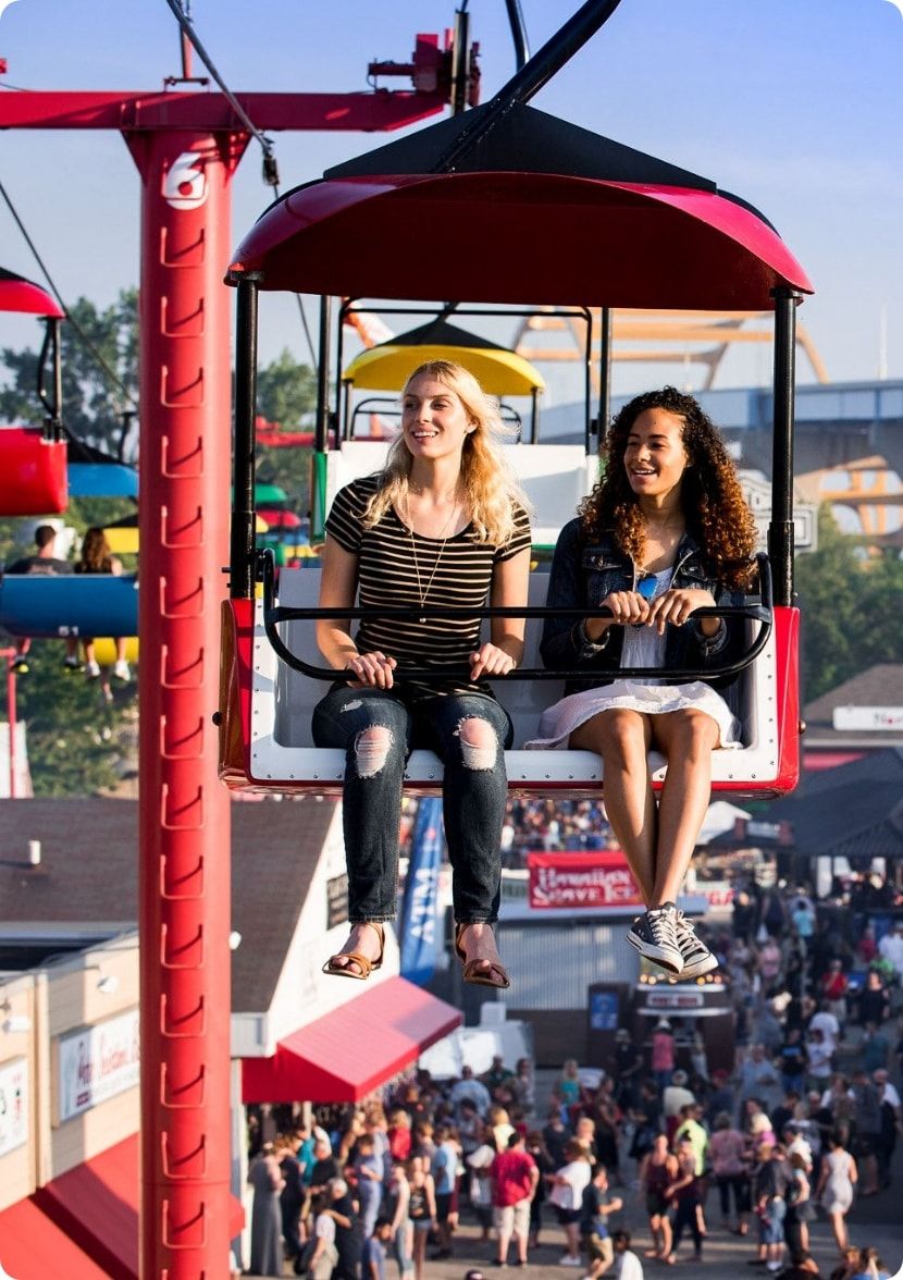 Two women ride the sky glider during Summerfest. 