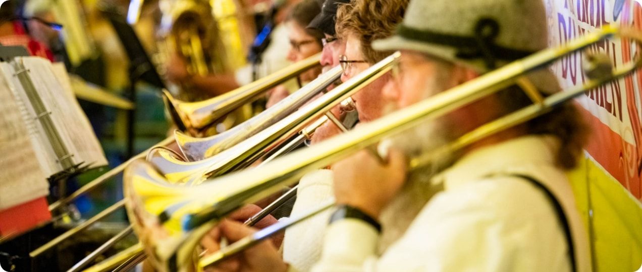 A group of trombonists playing during Oktoberfest. 
