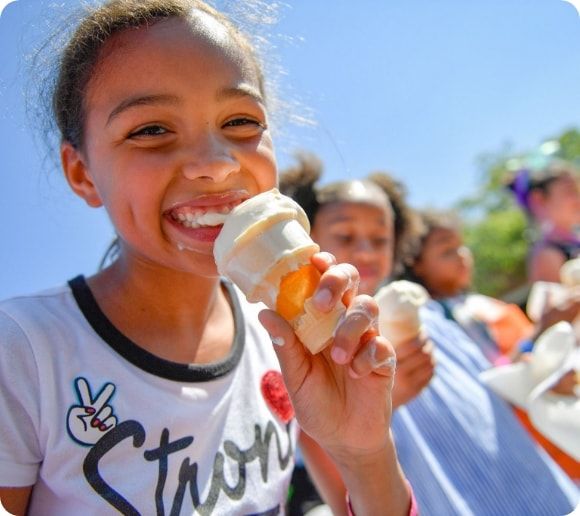 Kids enjoying ice cream cones. 