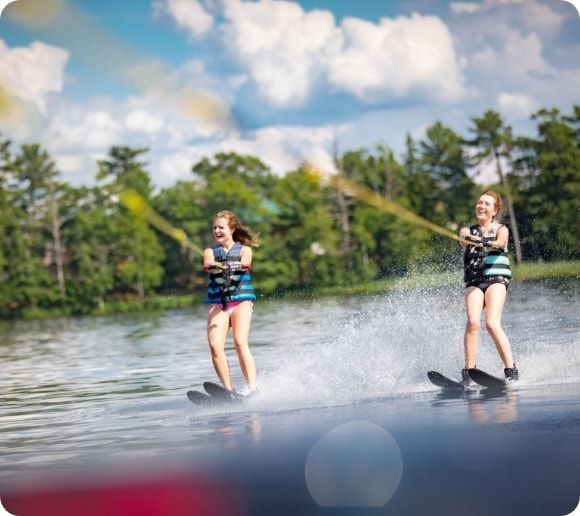 Two water skiers on a lake.  
